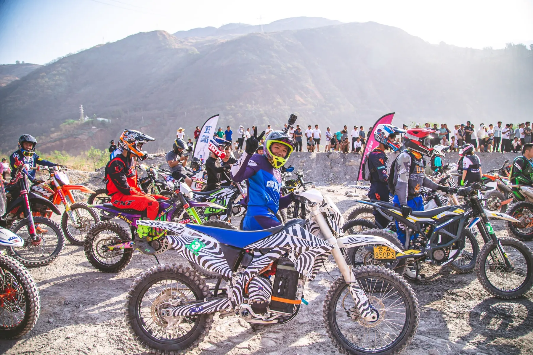 02MAX riders gathered on a mountain trail